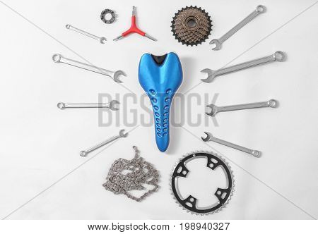 Bicycle parts and repair tools on white background