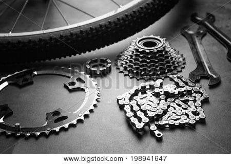 Bicycle parts and tools on gray background