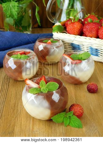 Chocolate sauce made of dark and white chocolate in little tasters on a wooden background
