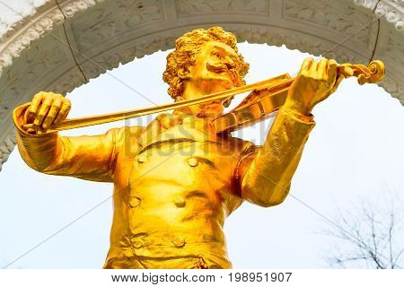 Vienna, Austria - April 4, 2015: Statue close up view of gilded bronze monument of Johann Strauss in Vienna, Austria