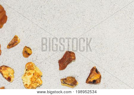 Amber. the pieces of amber in the sand on the beach. Sun stone natural mineral on the beach. Amber Shine on the beach. Amber Baltic sand