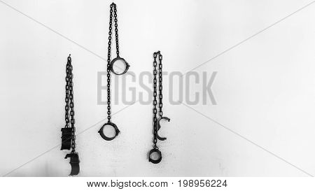 Prison fetters on a white wall Russia