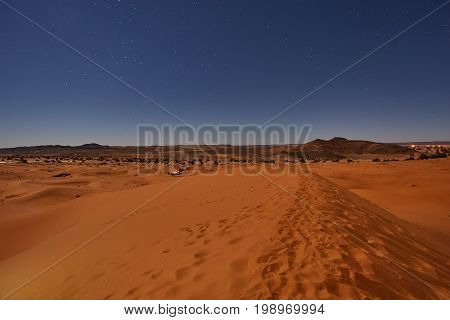 Camp In Sahara Desert In Night With Moon As Star