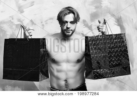 Caucasian Bearded Sexy Macho Man Holding Red Packages Or Bags