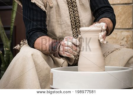 Hands of the old master at work