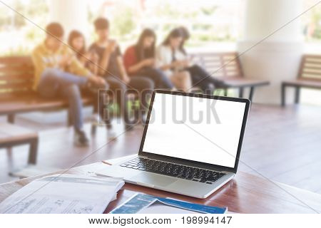 Happy group of students sitting at school with notebook on table
