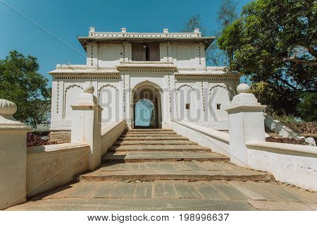 White gates in traditional indian architecture style. Old stairs and arch in historical India.
