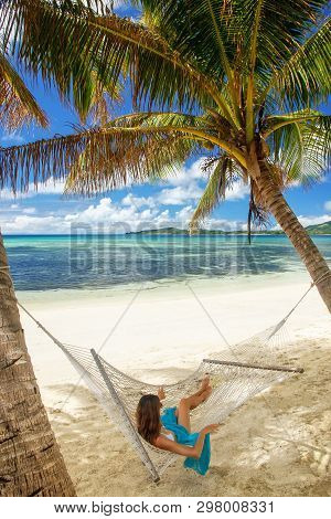 Young Woman Lying In A Hammock On A Tropical Beach, Nacula Island, Yasawas, Fiji