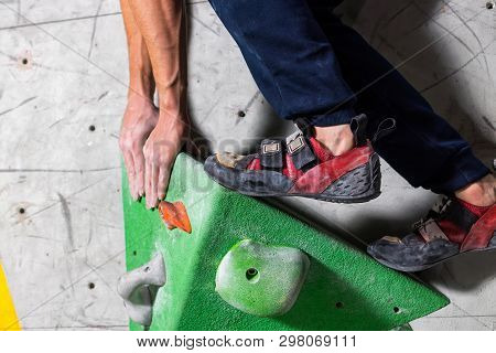 Rocky Shoe On A Tiny, Scanty Snare Stands With The Tip Of The Sock In Close-up On The Climbing Wall 