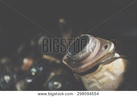 Disassembled Car Engine And Muffler At Garage