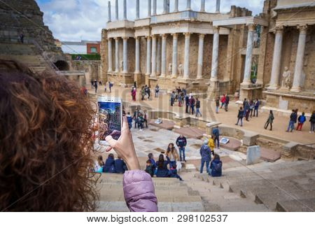 Tourist Girl Taking A Picture In The Antique Roman Theatre Of Merida, Spain.