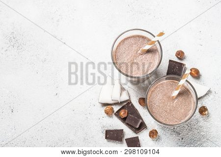 Chocolate Coconut Hazelnut Milkshake Or Smoothie In Two Glasses On White Table. Top View With Copy S