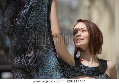 The Portrait Of A Sensual Pretty Model In Fashionable Gauzy Cloak Under The Daylight