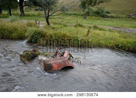 Abandoned Car Body In A Mountain River Yarovka In The Village Of Generalka Of The Altai Territory