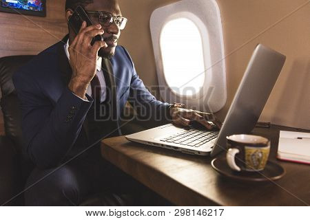 Young Attractive And Successful African American Businessman With Glassies Talking On The Phone And 