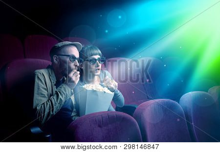 Teenager couple cuddling and watching the climax part of the movie