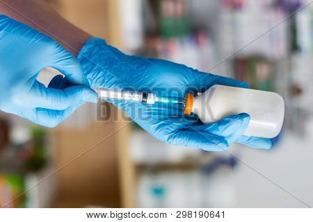 The Veterinarian Women With Blue Gloves Extract A White Drug With A Syringe