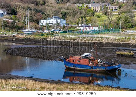Pier With Buildings And Boat In A Low Tide Clifden Bay