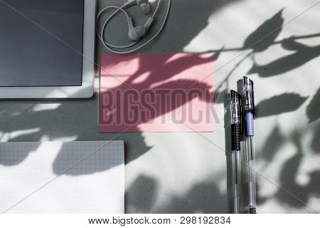 Work Office Space With A Tablet, Notebook, Pens And Headphones Top View, Flat Lay, Copy Space. Pink 