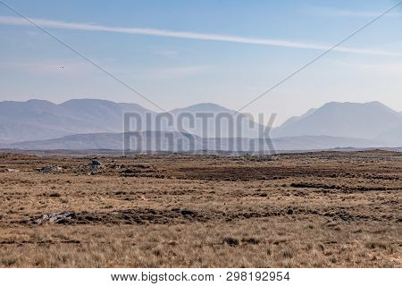 Rocks In A Bog With Twelve Bens Mountains In Background