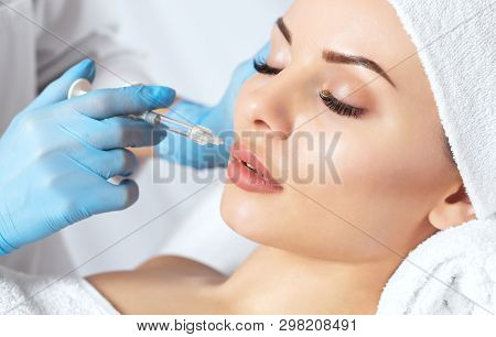The Doctor Cosmetologist Makes Prick In The Nose To Correct The Hump Of A Beautiful Woman In A Beaut