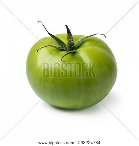Single fresh green unripe tomato isolated on white background