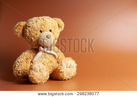 Soft Warm Cute Brown Teddy Bear On Color Backgroung. Isolated. Soft Brown Coffee Background. Copy Sp