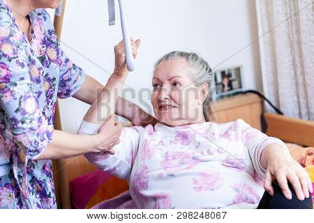 An Old Woman Pulls Herself Up On A Gallows