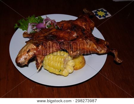 Close-up View To Grilled Cuy Aka Guinea Pig, Traditional Peruvian Dish With Salad Arequipa, Peru