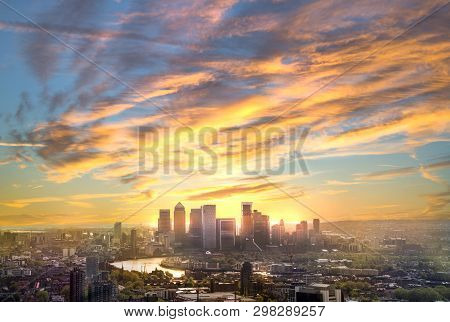 Canary Wharf At Sunset, London, Uk. Skyline View Of The Famous Financial Bank District At Golden Sun