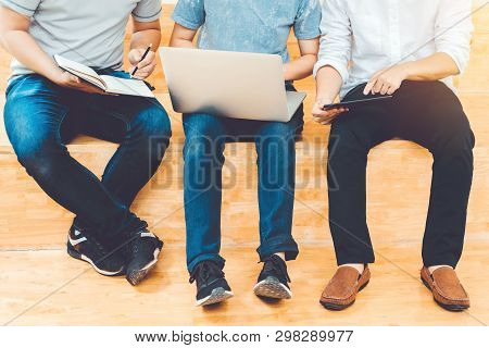 High School Or College Students Studying And Reading Together In Library