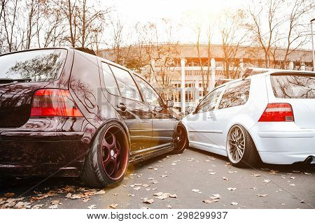 Two Modified Low Cars In Brown And Light Blue Color. Stance Custom Cars With A Forged Polished Wheel