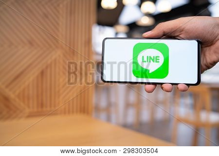 Chiang Mai, Thailand - Mar. 23,2019: Man Holding Xiaomi Mi Mix 3 With Line Apps On Screen. Line Is A