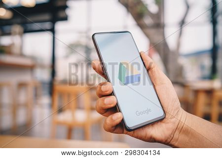 Chiang Mai, Thailand - Mar. 23,2019: Man Hands Holding Xiaomi Mi Mix 3 With Google Drive Apps On Scr