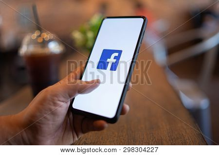 Chiang Mai, Thailand - Mar. 24,2019: Man Holding Xiaomi Mi Mix3 With Facebook App On The Screen. Fac