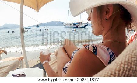 Beeautiful Young Woman Relaxing On The Sunbed By The Sea