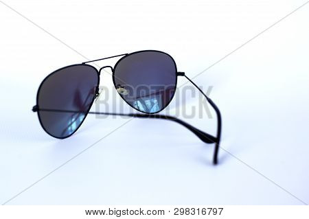 Blue Mirrored Sunglasses With Anti-reflective Coating And Uv Protection On A White Background. Close