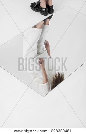 Anonymous Woman Reflecting In Glass On Floor