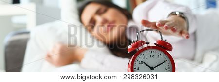 Sleepy Young Woman Portrait With One Opened Eye Trying Kill Alarm Clock. Early Wake Up Not Getting E