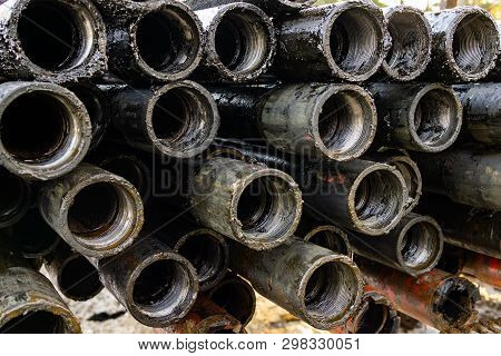 Oil Drill Pipe. Rusty Drill Pipes Were Drilled In The Well Section. Downhole Drilling Rig. Laying Th