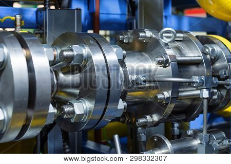 Steel Pipeline With Flanges. The Flanges Are Fastened With Powerful Bolts With Nuts.