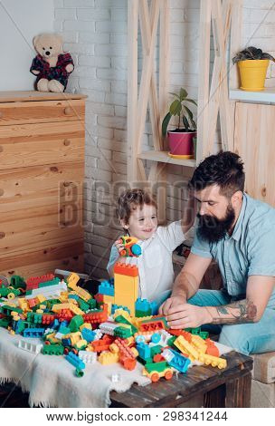 Happy Preschooler. Child Holds Plastic Colorful Car In Small Hand And Plays With Father. Family Time