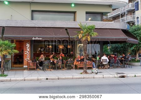 Thessaloniki, Greece - April 26 2019: People Enjoying Their Coffee At A City Center Bar. Unidentifie