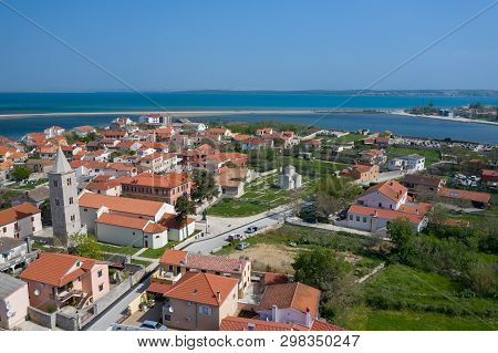 Aerial View Of City Of Nin. Summer Time In Dalmatia Region Of Croatia. Coastline And Turquoise Water