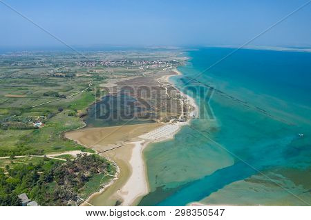 Aerial View Of City Of Nin. Summer Time In Dalmatia Region Of Croatia. Coastline And Turquoise Water