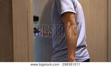 Motion Blurred Scene Of Hand Man Open The Door Into His Hotel Room After Using An Electronic Securit