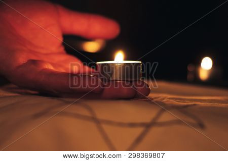 Candles Burning Over The Star Of David In Memory Of The Dead.