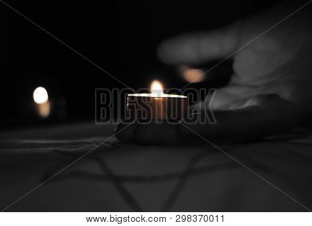 Candles Burning Over The Star Of David In Memory Of The Dead.