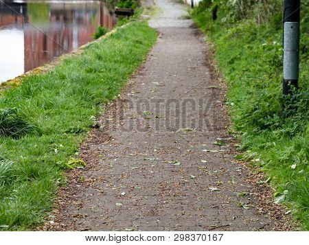 The Cobbled Towpath And The Green Grass On Its Edges