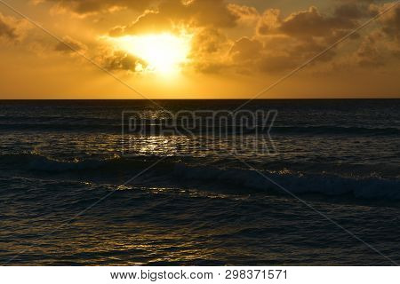 Brilliant Firey Skies At Sunset Over The Ocean In Aruba.